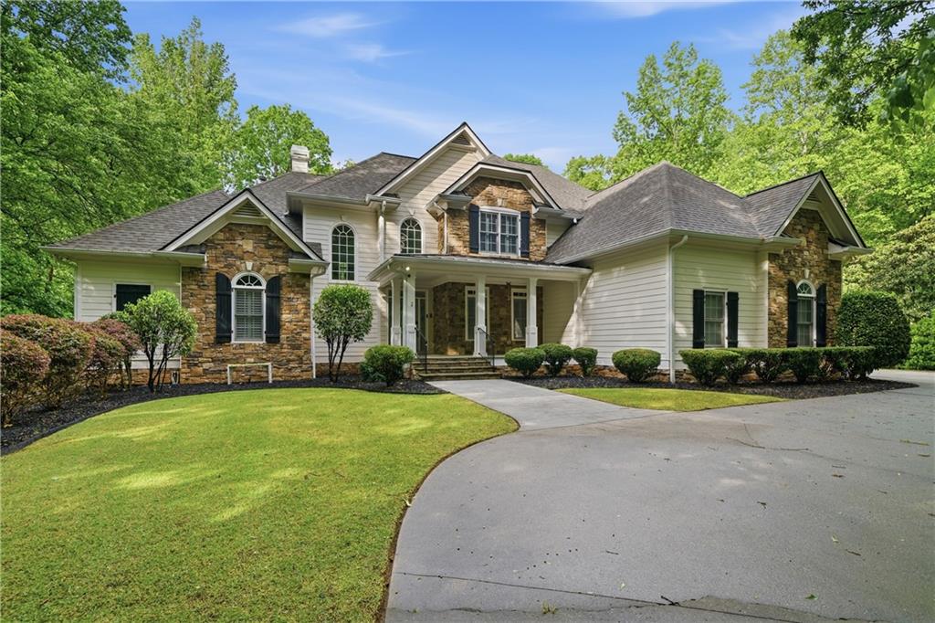 4185 Pool Road Winston, GA 30187 - Photo 1 of 39 a front view of a house with a garden and porch