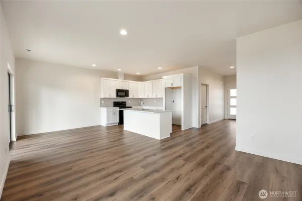 a kitchen with stainless steel appliances a refrigerator stove microwave and cabinets