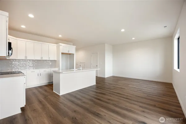 a view of a kitchen counter space wooden floor and windows