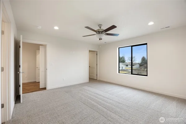an empty room with windows and closet