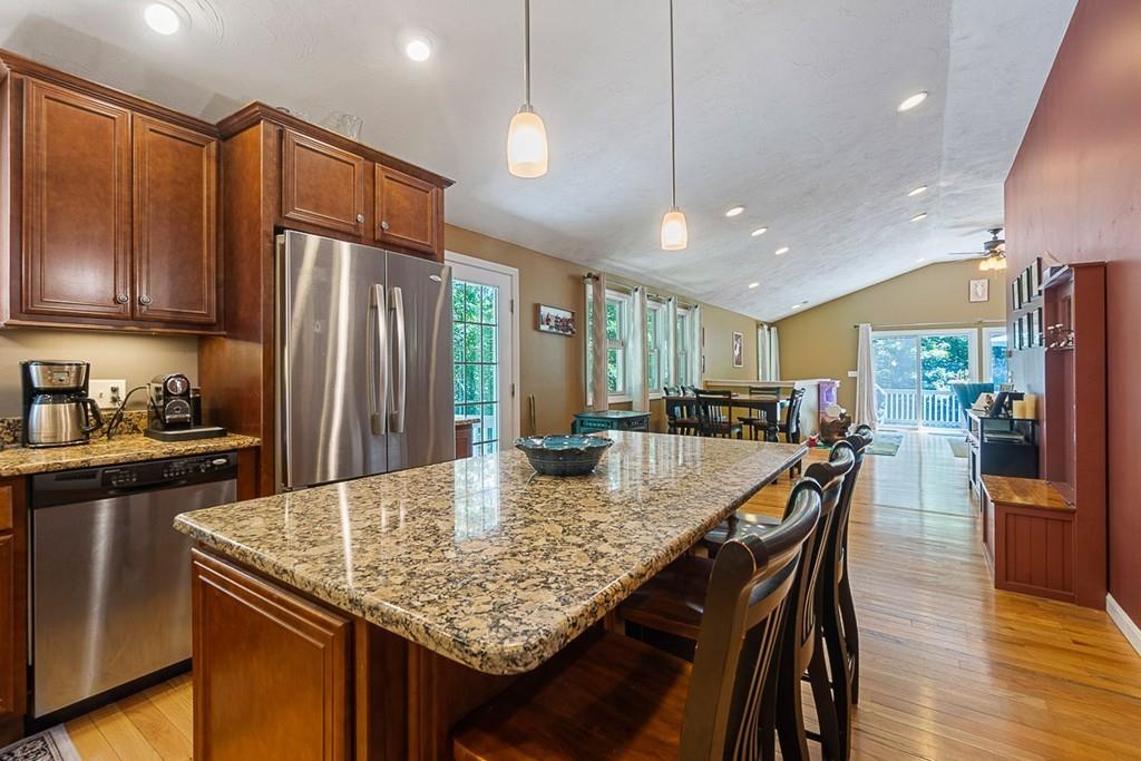 37 Coal Kiln Road Princeton, MA 01541 - Photo 4 of 26 a kitchen with granite countertop a table chairs stainless steel appliances and cabinets