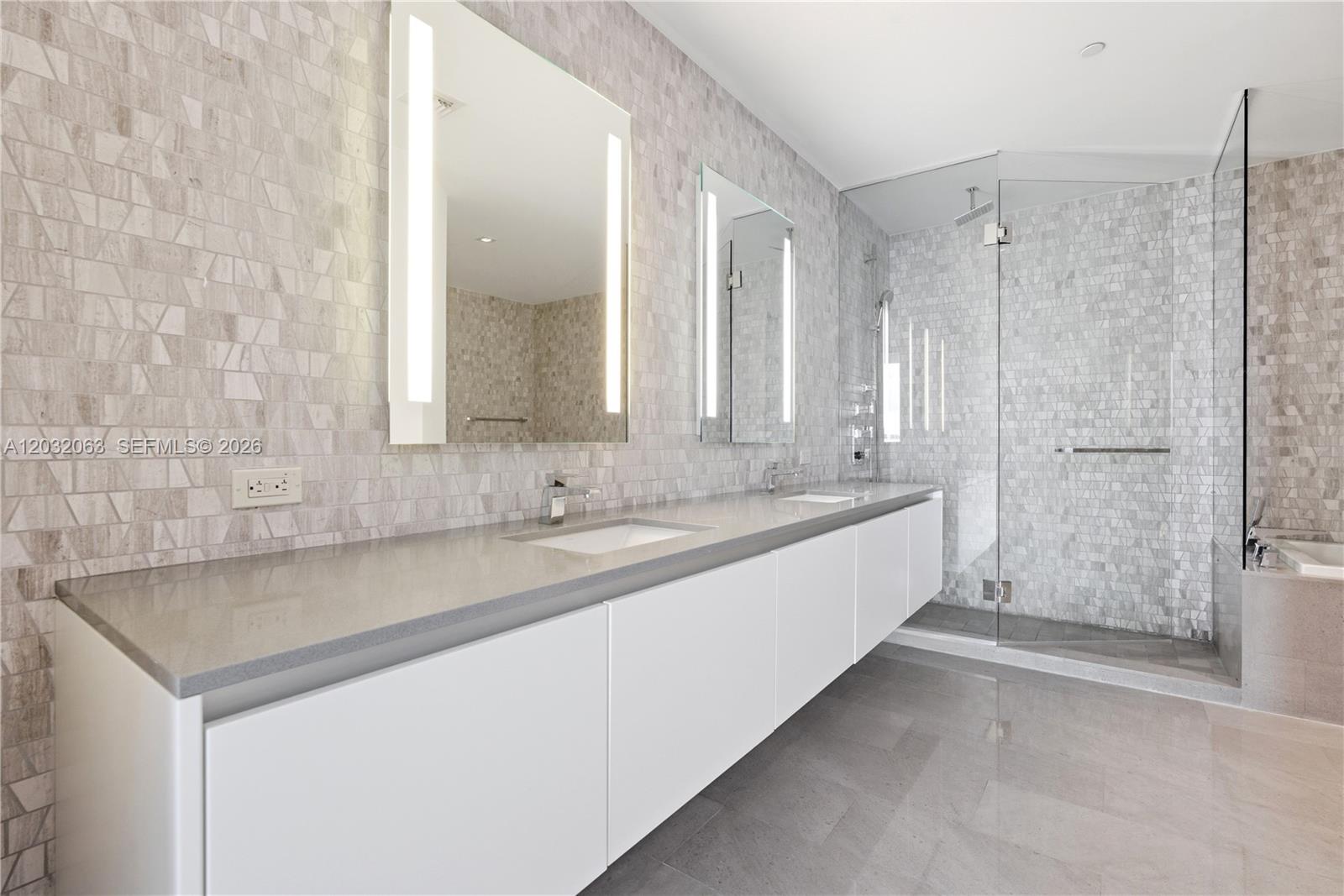 88 Southwest 7th Street, Unit 2302 Miami, FL 33130 - Photo 14 of 26 a large bathroom with a sink and a mirror