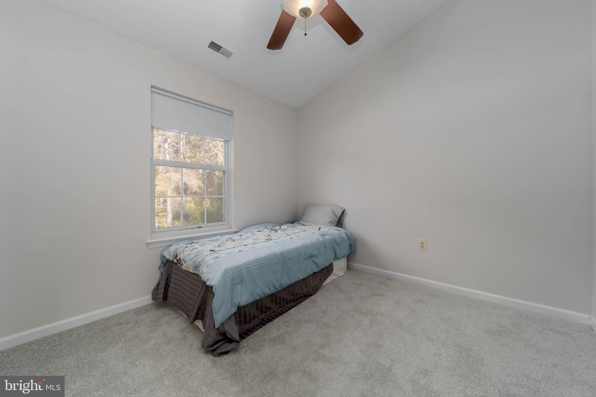 620 Small Reward Road Huntingtown, MD 20639 - Photo 20 of 33 a room with a bed and a chandelier fan