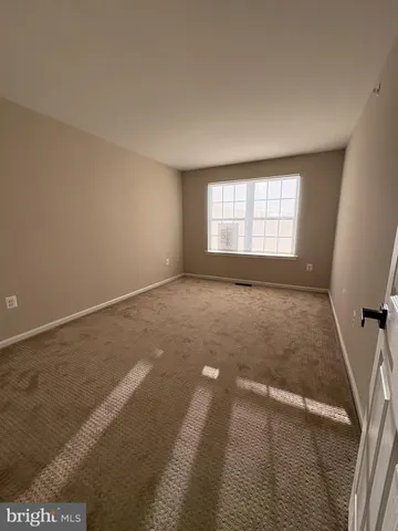 an empty room with a empty space and windows