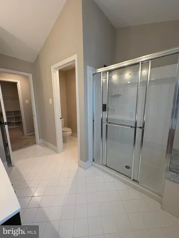 a bathroom with a glass door shower