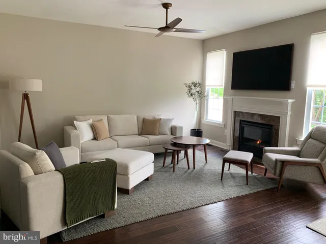 a living room with furniture a fireplace and a flat screen tv