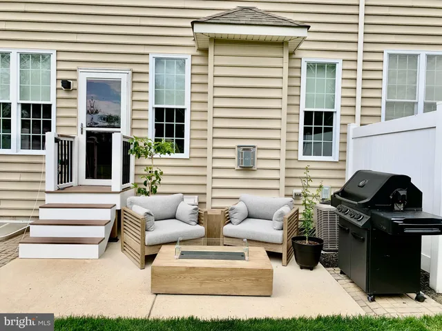 a view of a patio with couches and a dining table and chairs