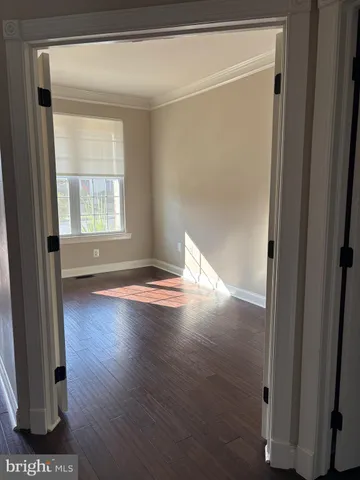 a view of a livingroom with wooden floor and a window