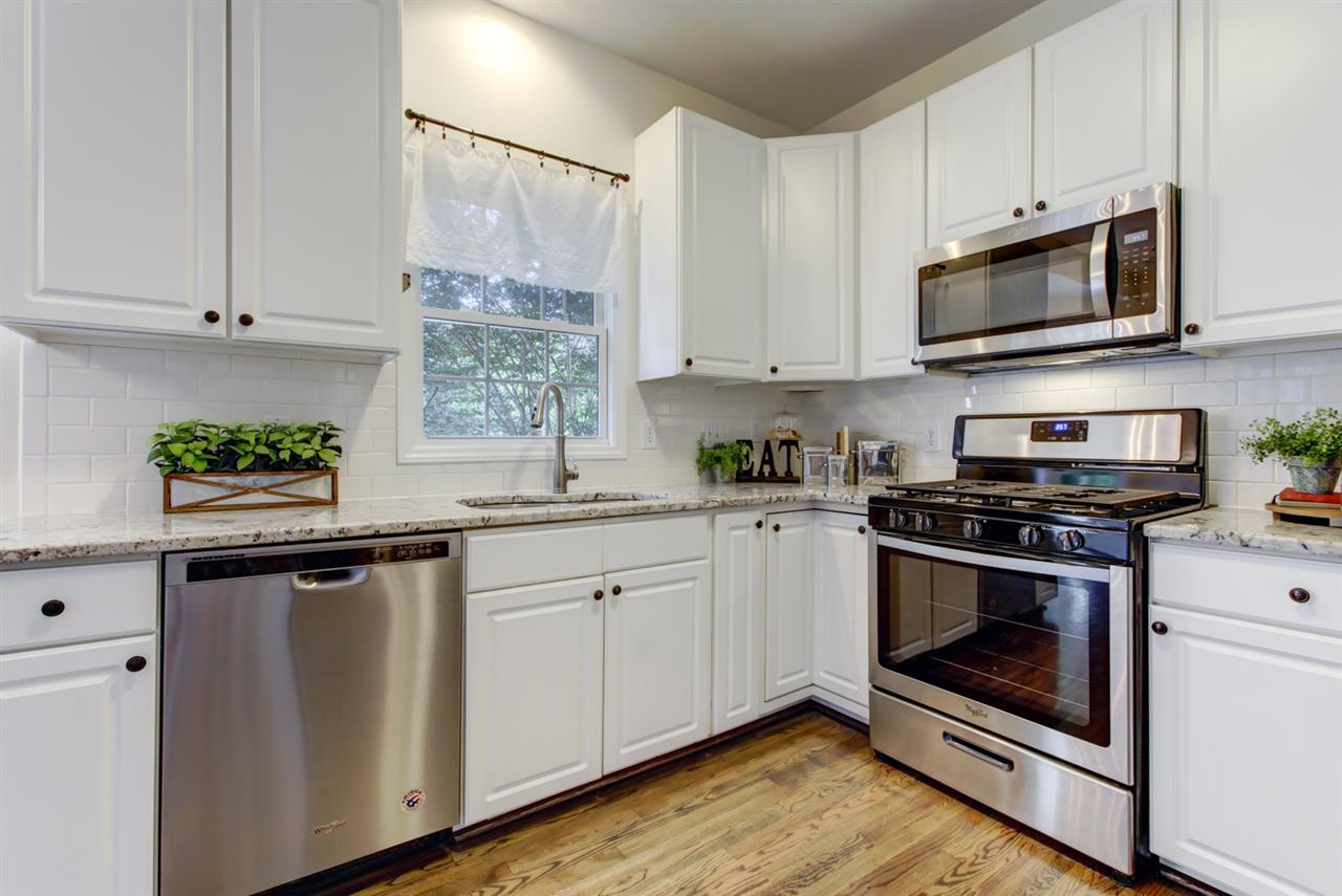 2316 Lemuel Drive Raleigh, NC 27615 - Photo 2 of 13 Elegant TILE back splash and GRANITE counters are some of the beautiful features of the spacious kitchen. The refinished HARDWOODS and new STAINLESS STEEL appliances are other upgrades you will enjoy. Kitchen
