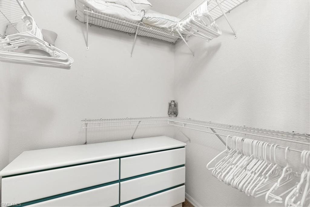 2090 Aberdeen Lane, Unit 101 Naples, FL 34109 - Photo 14 of 42 a view of a room with racks on the wall