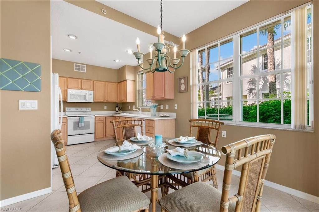 2090 Aberdeen Lane, Unit 101 Naples, FL 34109 - Photo 15 of 42 a view of a dining room with furniture window and outside view
