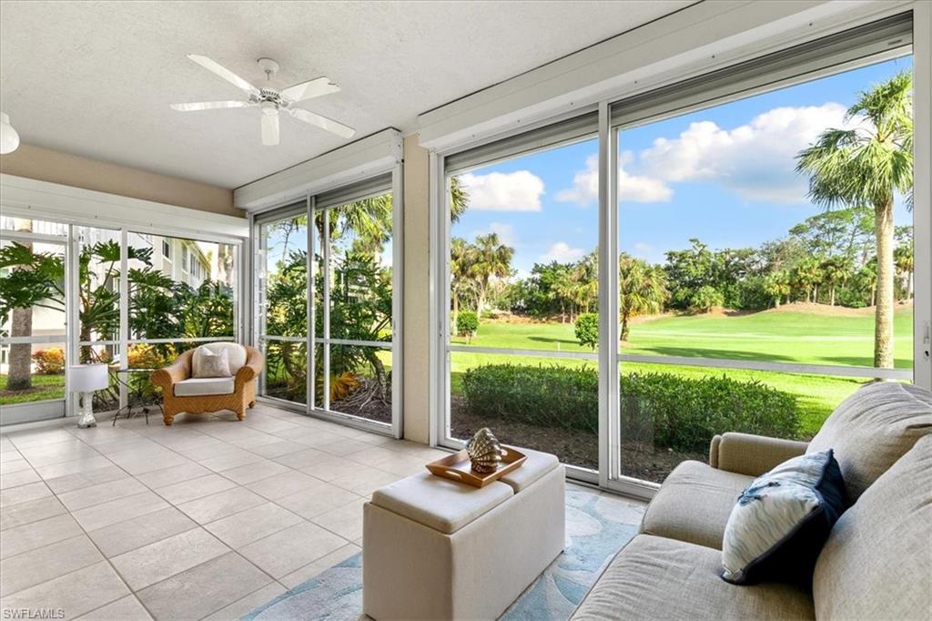 2090 Aberdeen Lane, Unit 101 Naples, FL 34109 - Photo 20 of 42 a living room with patio furniture and a floor to ceiling window
