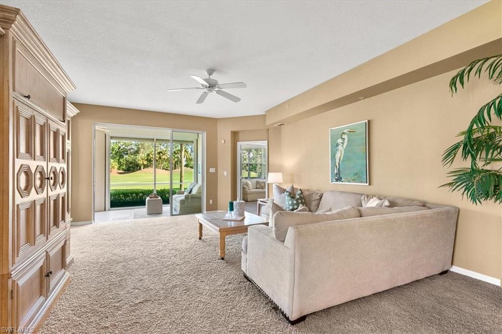 2090 Aberdeen Lane, Unit 101 Naples, FL 34109 - Photo 2 of 42 a living room with furniture and a large window