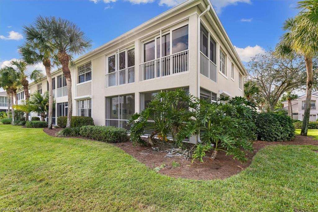 2090 Aberdeen Lane, Unit 101 Naples, FL 34109 - Photo 26 of 42 a front view of a house with a yard