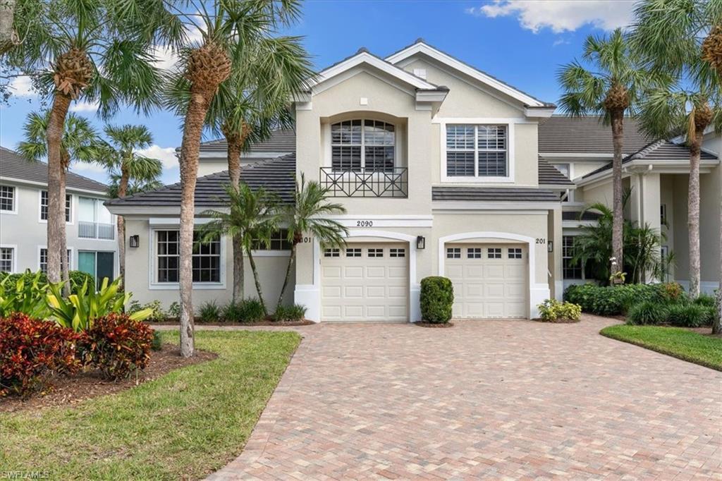 2090 Aberdeen Lane, Unit 101 Naples, FL 34109 - Photo 27 of 42 a front view of house with yard and green space