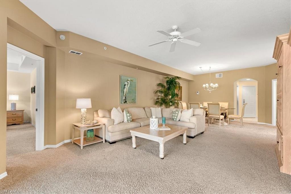 2090 Aberdeen Lane, Unit 101 Naples, FL 34109 - Photo 4 of 42 a living room with furniture and a chandelier
