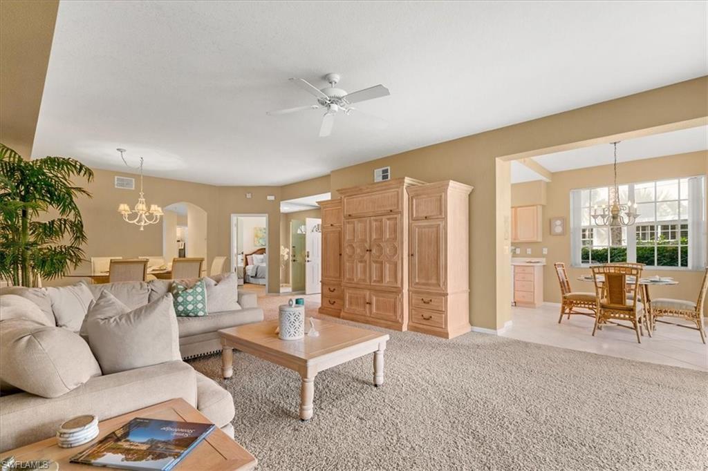 2090 Aberdeen Lane, Unit 101 Naples, FL 34109 - Photo 5 of 42 a living room with furniture and a large window