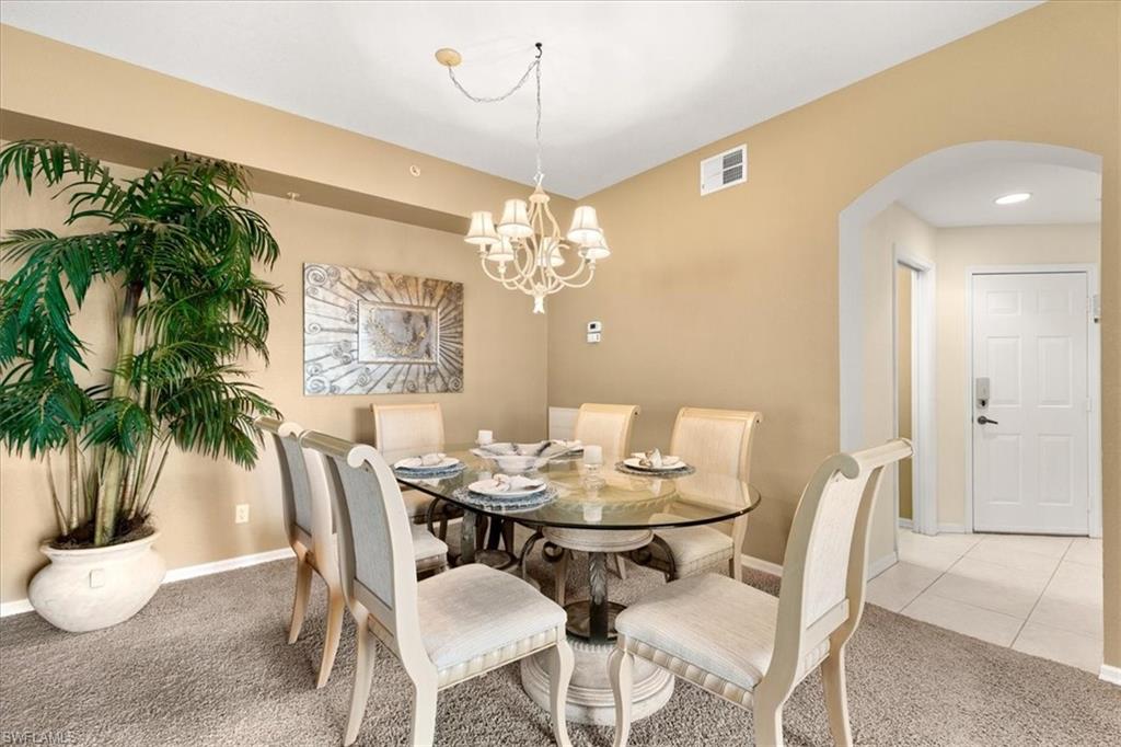 2090 Aberdeen Lane, Unit 101 Naples, FL 34109 - Photo 6 of 42 a view of a dining room with furniture and chandelier