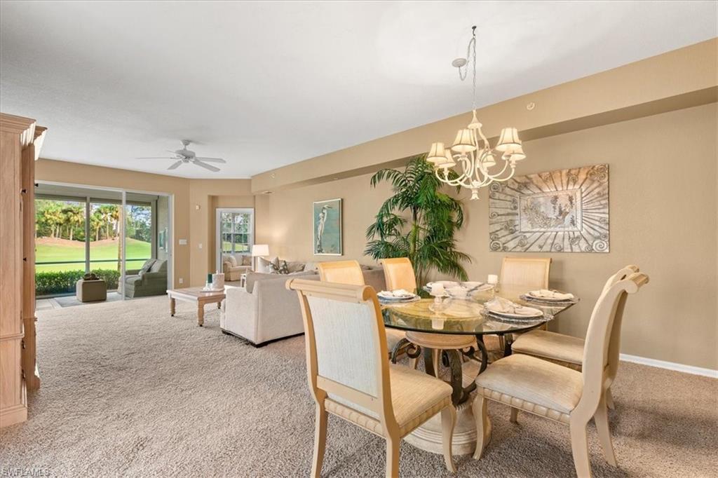 2090 Aberdeen Lane, Unit 101 Naples, FL 34109 - Photo 7 of 42 a dining room with furniture a chandelier and window