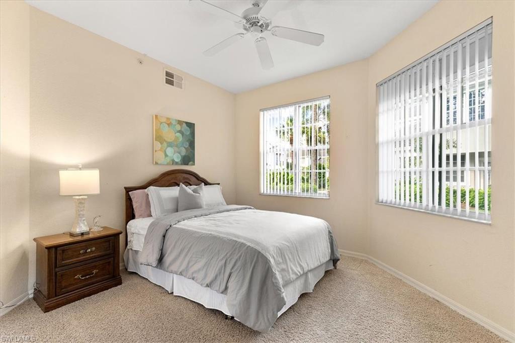 2090 Aberdeen Lane, Unit 101 Naples, FL 34109 - Photo 8 of 42 a bedroom with a bed and a window