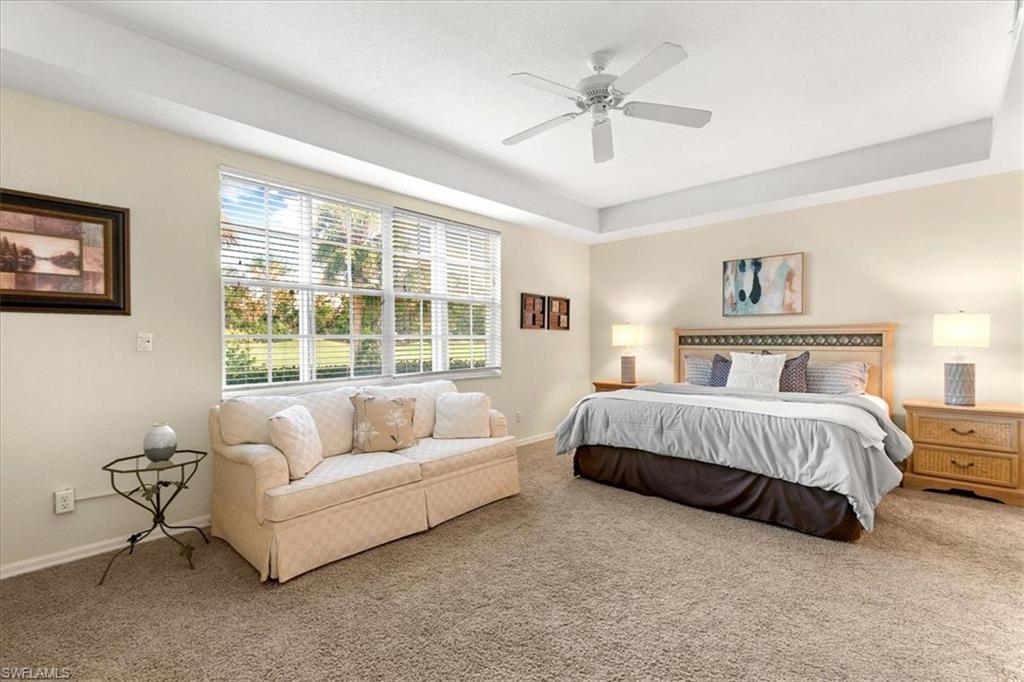2090 Aberdeen Lane, Unit 101 Naples, FL 34109 - Photo 9 of 42 a spacious bedroom with a bed couch and window