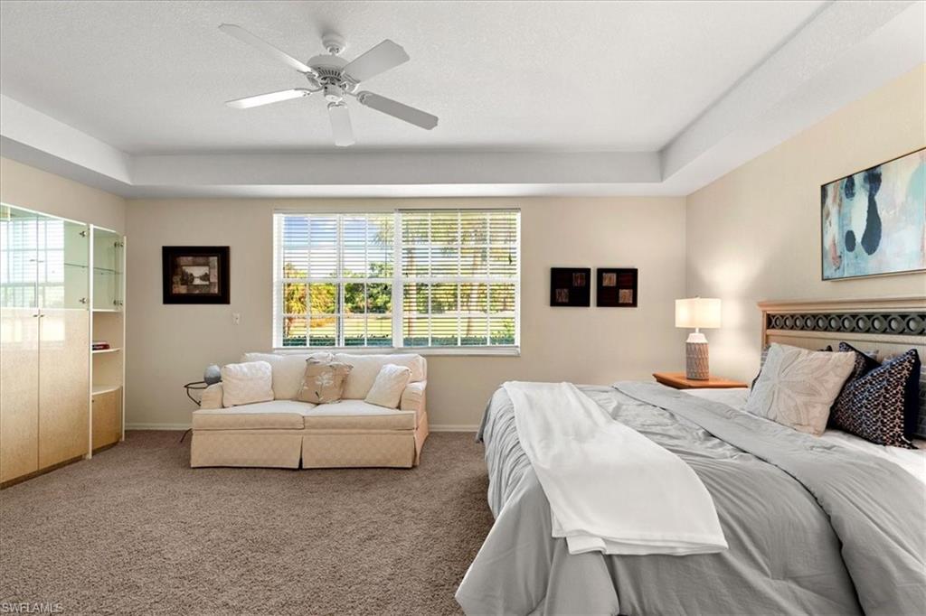 2090 Aberdeen Lane, Unit 101 Naples, FL 34109 - Photo 10 of 42 a spacious bedroom with a bed and a large window