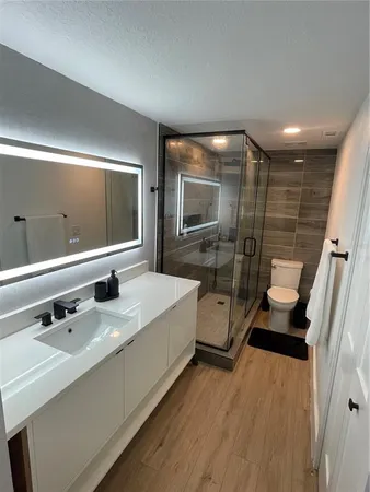 a bathroom with a double vanity sink a mirror and shower