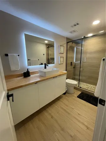 a bathroom with a double vanity sink and mirror