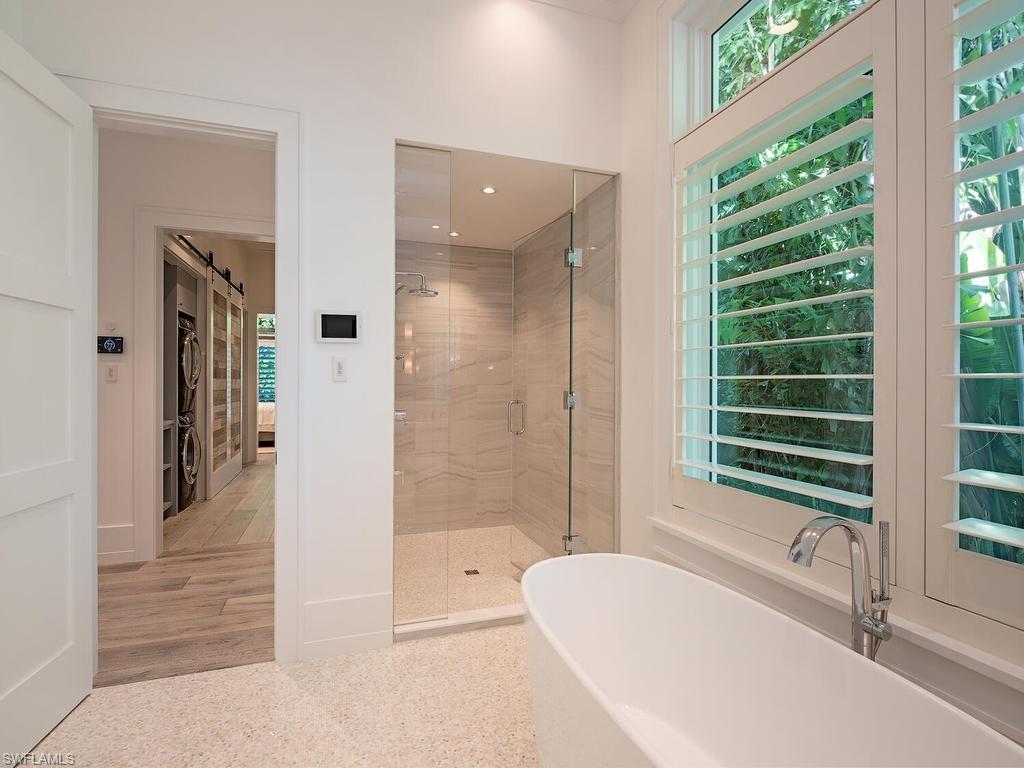 225 4th Avenue North Naples, FL 34102 - Photo 13 of 42 a bathroom with a bathtub and a shower