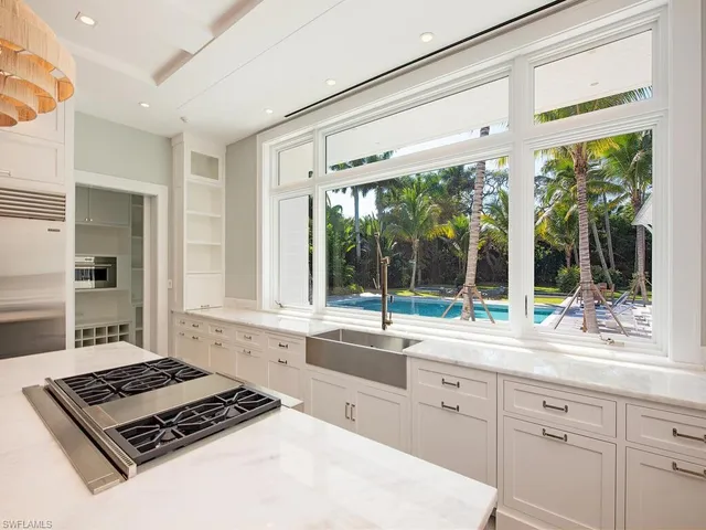 a kitchen with a stove a sink and cabinets