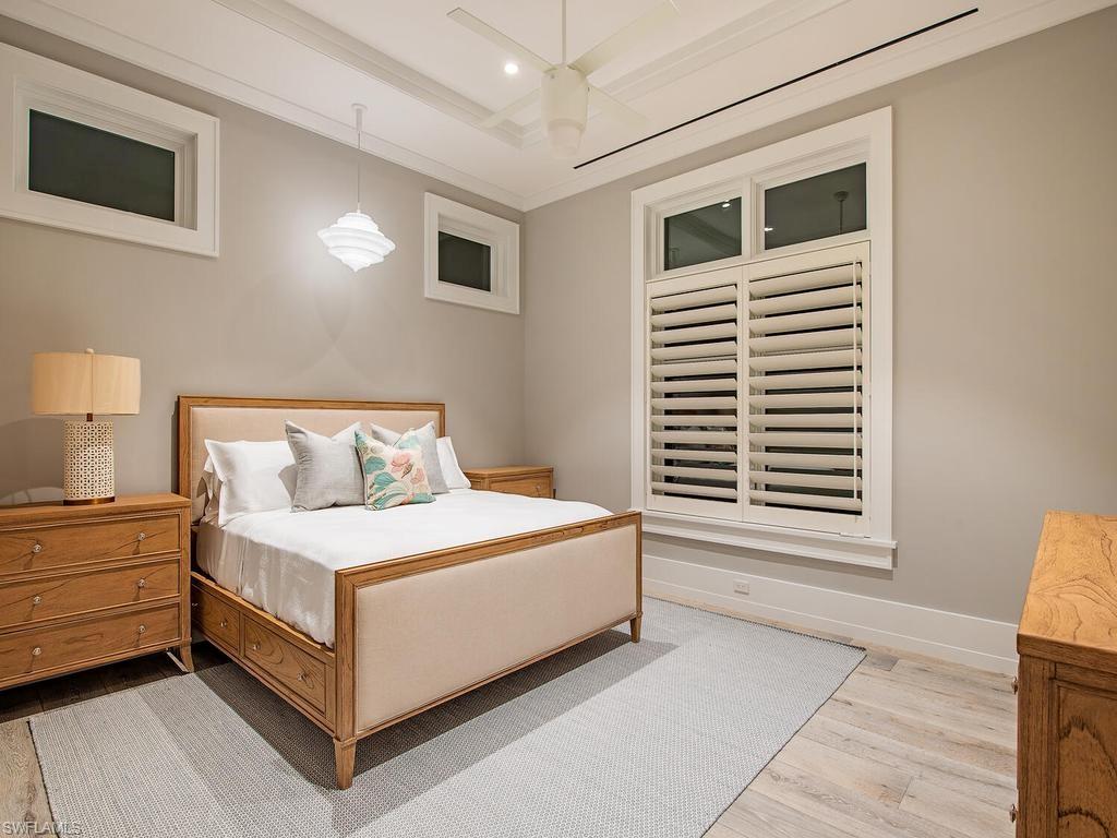 225 4th Avenue North Naples, FL 34102 - Photo 19 of 42 a white bed sitting in a bedroom next to a window