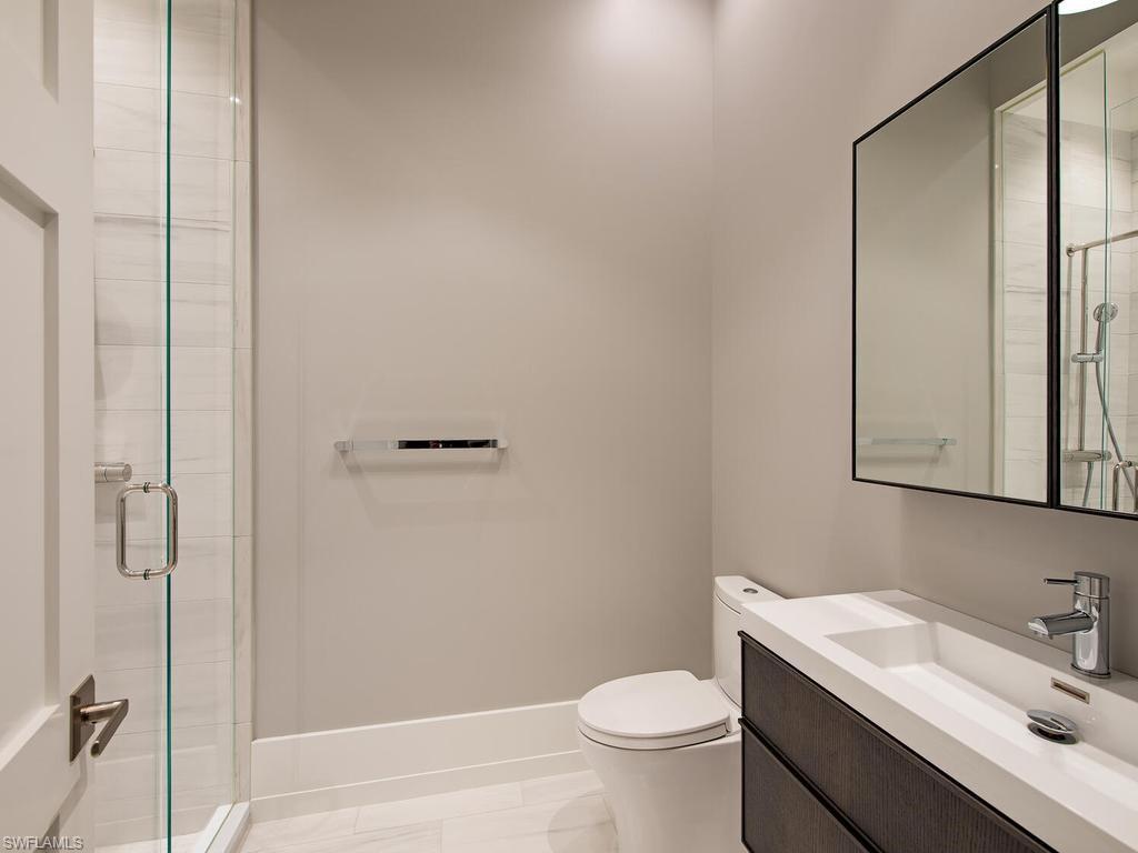 225 4th Avenue North Naples, FL 34102 - Photo 20 of 42 a bathroom with a sink toilet and shower