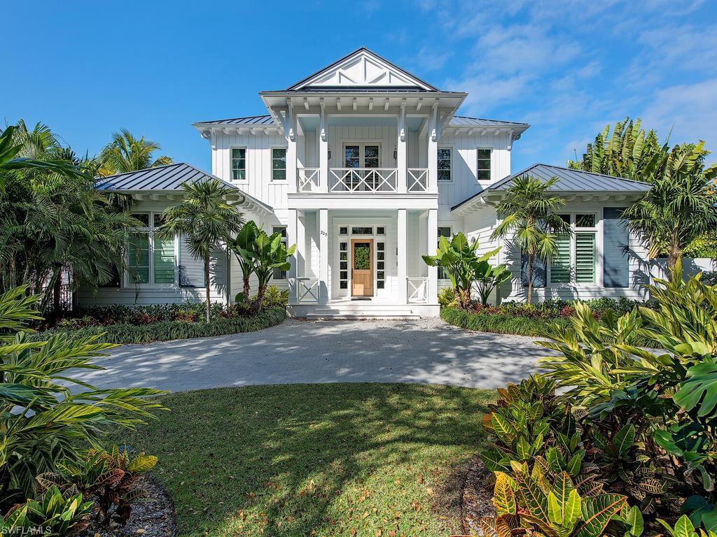 225 4th Avenue North Naples, FL 34102 - Photo 2 of 42 a front view of a house with garden