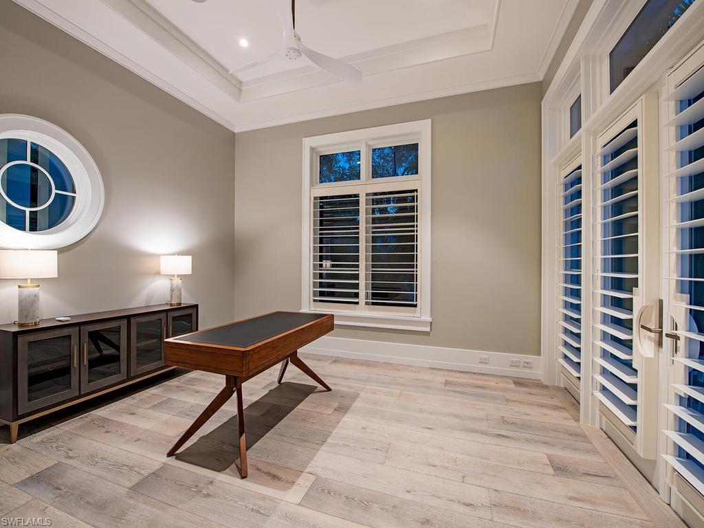 225 4th Avenue North Naples, FL 34102 - Photo 23 of 42 a living room with furniture and a fireplace