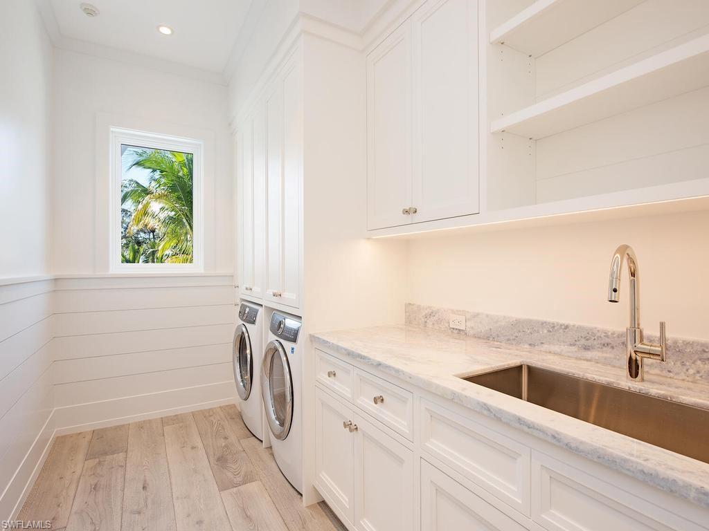 225 4th Avenue North Naples, FL 34102 - Photo 25 of 42 a view of a kitchen with a sink dishwasher and a window