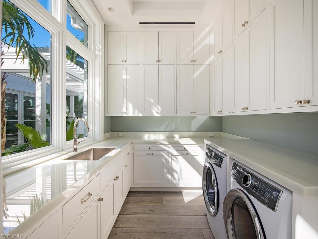 225 4th Avenue North Naples, FL 34102 - Photo 26 of 42 a utility room with stainless steel appliances white cabinets and a sink