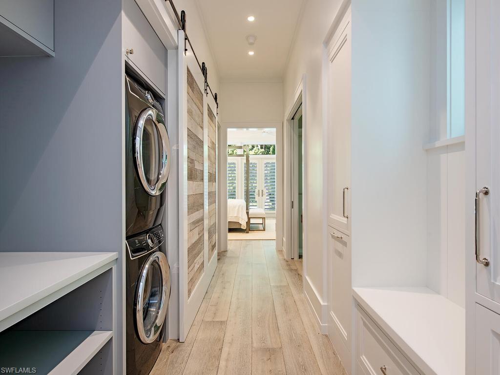 225 4th Avenue North Naples, FL 34102 - Photo 27 of 42 a view of a hallway with washer and dryer