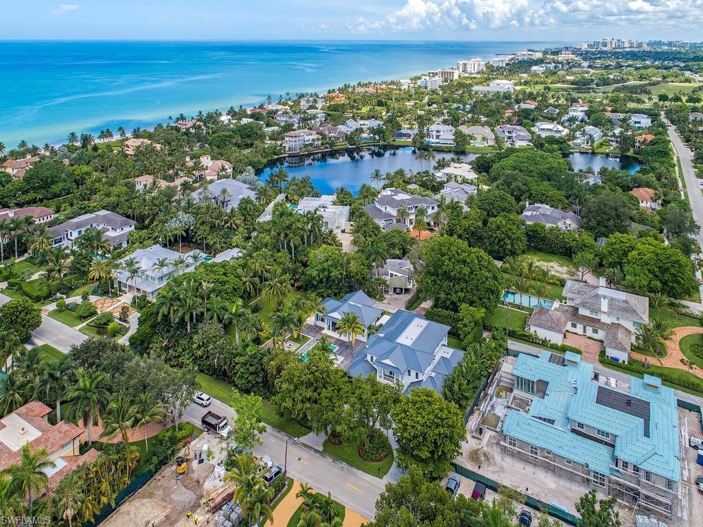 225 4th Avenue North Naples, FL 34102 - Photo 28 of 42 an aerial view of a city with lots of residential buildings ocean and mountain view in back