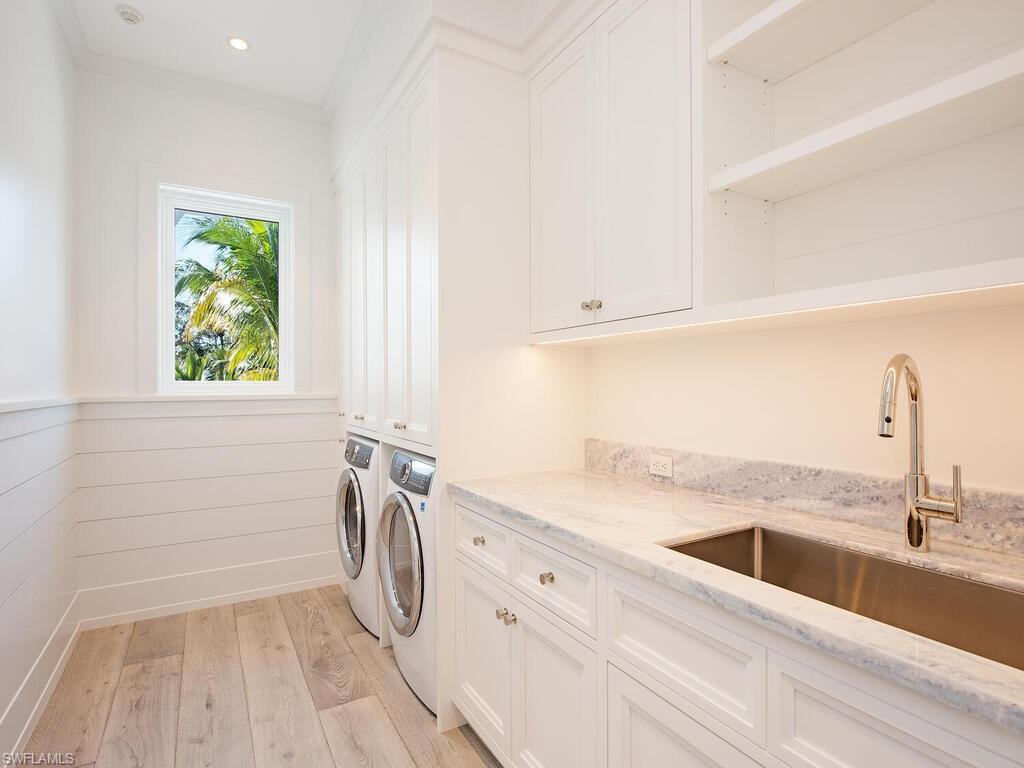 225 4th Avenue North Naples, FL 34102 - Photo 28 of 41 a view of a kitchen with a sink dishwasher and a window
