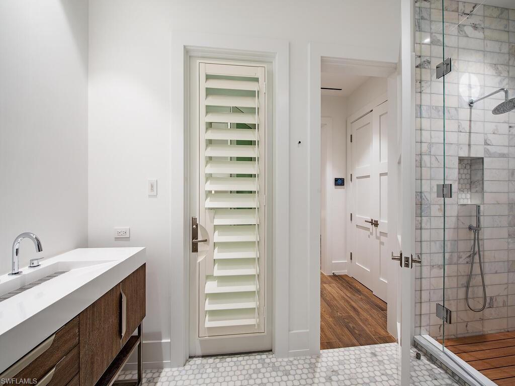 225 4th Avenue North Naples, FL 34102 - Photo 37 of 41 a bathroom with a sink and shower