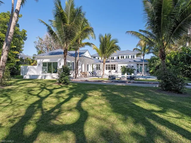 a view of swimming pool with palm trees