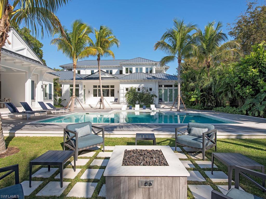 225 4th Avenue North Naples, FL 34102 - Photo 40 of 42 a view of a swimming pool with chairs