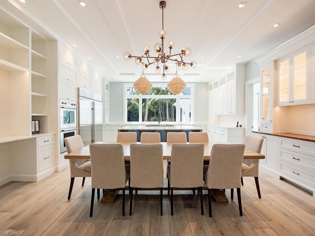 225 4th Avenue North Naples, FL 34102 - Photo 6 of 42 a view of a dining room with furniture window and wooden floor