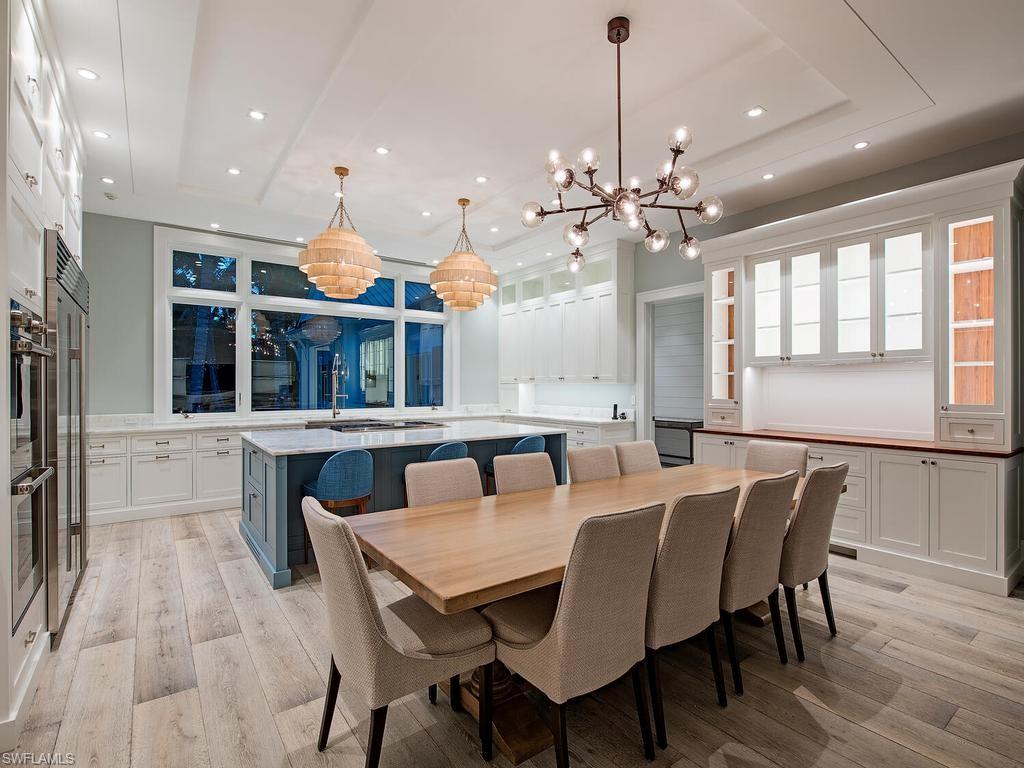 225 4th Avenue North Naples, FL 34102 - Photo 7 of 42 a view of a dining room with furniture window and wooden floor