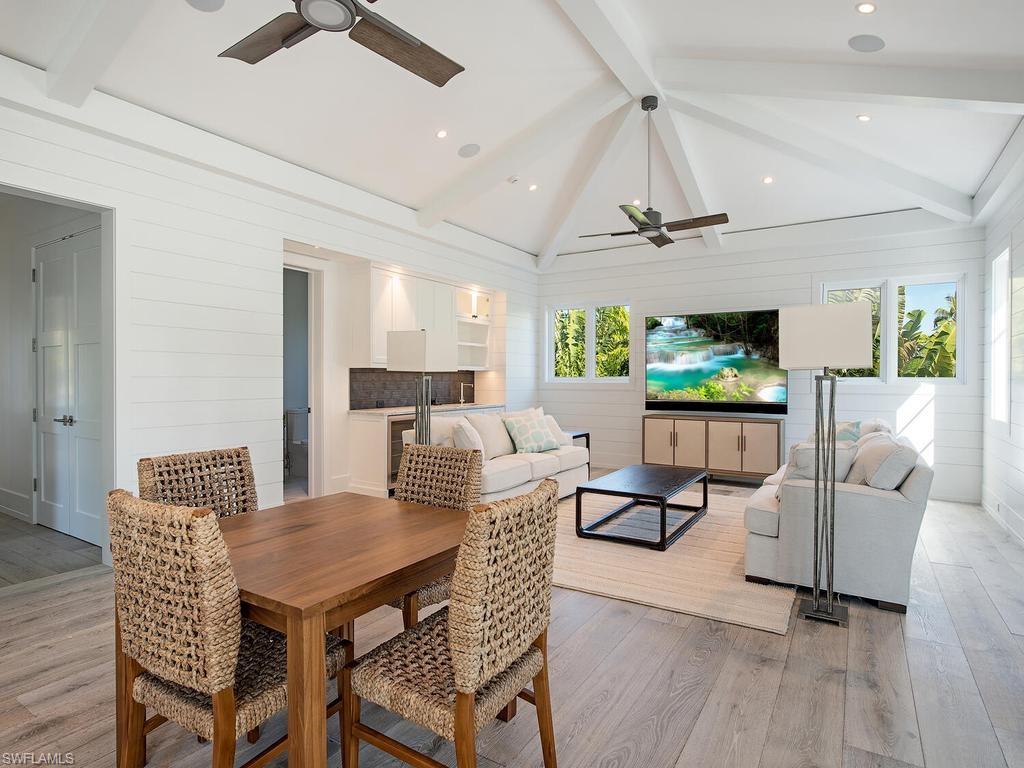 225 4th Avenue North Naples, FL 34102 - Photo 10 of 42 a view of a dining room with furniture window and wooden floor