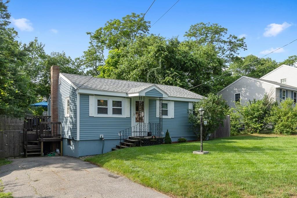 24 Springwell Road Billerica, MA 01821 - Photo 14 of 16 a front view of house with yard and green space