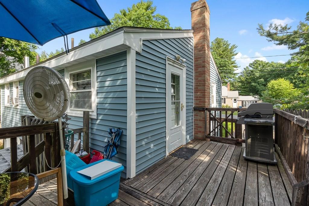 24 Springwell Road Billerica, MA 01821 - Photo 15 of 16 a view of deck with table and chairs potted plants with wooden floor