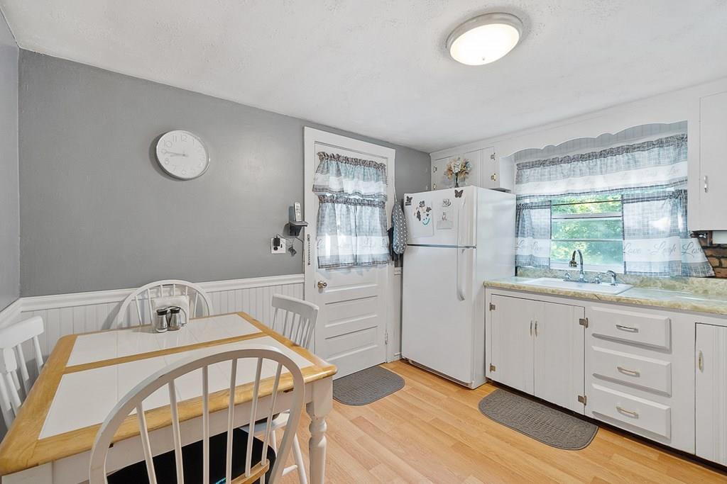 24 Springwell Road Billerica, MA 01821 - Photo 2 of 16 a kitchen with a refrigerator a sink and cabinets