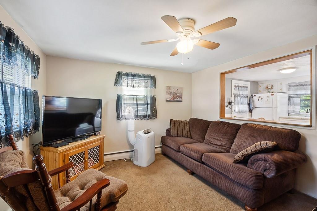 24 Springwell Road Billerica, MA 01821 - Photo 5 of 16 a living room with furniture and a flat screen tv