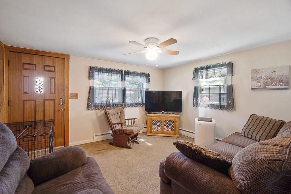 24 Springwell Road Billerica, MA 01821 - Photo 6 of 16 a living room with furniture and a flat screen tv